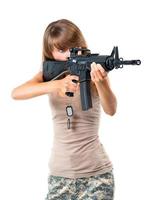 Soldier young beautiful girl with a gun in his hand on white photo