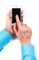 Businessman's hands using smartphone on white photo