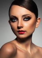 Portrait of a beautiful woman with a glamorous retro makeup photo