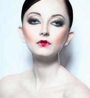 Portrait of a beautiful woman like doll with a glamorous cool makeup photo