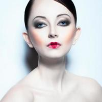 Portrait of a beautiful woman like doll with a glamorous cool makeup photo