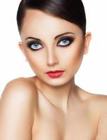 Portrait of a beautiful young woman with a glamorous retro makeup photo