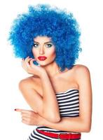 Portrait of a young beautiful girl with bright makeup in blue wig photo