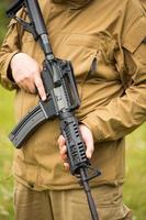 Man in camouflage with a shotgun photo