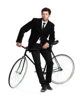 Attractive man in a classic suit with a bicycle on a white photo