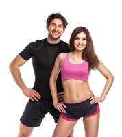 Athletic man and woman after fitness exercise on the white photo