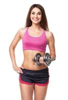 Beautiful slim woman with dumbbells, isolated on white photo