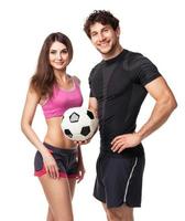 Athletic man and woman with ball on the white photo