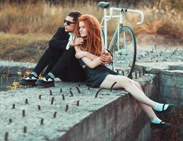 Guy with the girl and bicycle outdoors photo