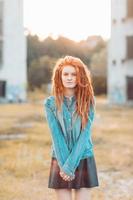 Young stylish girl with dreadlocks outdoors photo