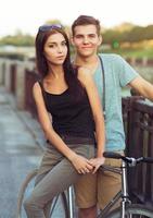 Happy couple with bike in the city photo