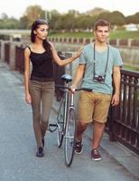 Happy couple with bike in the city photo