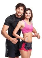 Athletic man and woman after fitness exercise with a finger up on the white photo