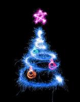 Christmas tree made by sparkler on a black photo