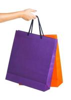 Two paper Shopping bags in woman hand with reflection on white photo