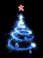 Christmas tree made by sparkler on a black photo