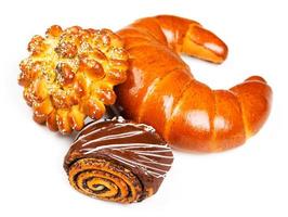 Fresh and tasty buns with with sesame and poppy seeds, bagel with jam and roll with chocolate photo