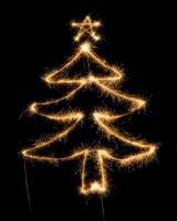 Christmas tree made by sparkler on a black photo