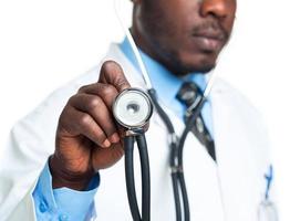 Doctor with a stethoscope in the hands on white photo