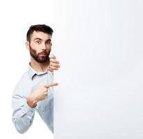 A young bearded man showing blank signboard, isolated over white photo