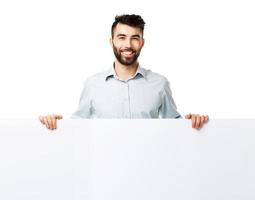 A young bearded man showing blank signboard, isolated over white photo