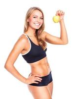 Young smiling girl holding green apple in hand photo