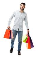 Handsome man holding shopping bags on white background photo