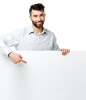 A young bearded man showing blank signboard, isolated over white photo