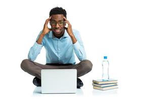 African american college student with headache sitting on white background with laptop photo