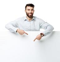 A young bearded man showing blank signboard, isolated over white photo