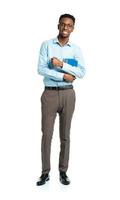 Happy african american college student standing with books in his hands on white photo