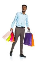 Happy african american man holding shopping bags on white background photo