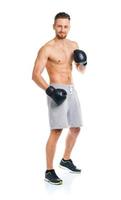 Athletic attractive man wearing boxing gloves on the white photo