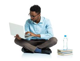 africano americano Universidad estudiante sentado con ordenador portátil en blanco foto