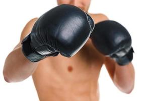 Athletic attractive man wearing boxing gloves on the white photo