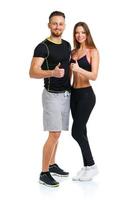 Sport man and woman after fitness exercise with a finger up on the white photo