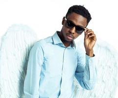 African American man with angel wings in sunglasses photo