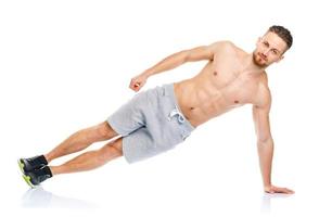 Sport attractive man doing fitness exercises on the white photo