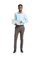 Happy african american college student with laptop standing on white photo