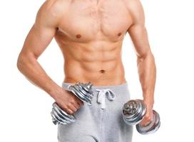 Sport man with dumbbells on the white photo