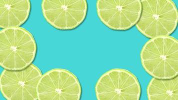 Sliced lime fruit on blue background with stop motion effect. Seamless loop video