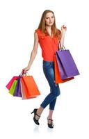 Happy caucasian woman holding shopping bags on white. Holidays concept photo
