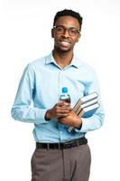 Happy african american college student with books and bottle of water in his hands standing on white photo