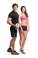 Sport couple - man and woman with dumbbells on the white photo
