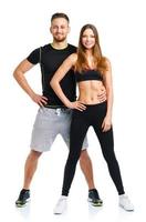 Sport couple - man and woman after fitness exercise on the white photo