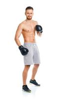 Athletic attractive man wearing boxing gloves on the white photo