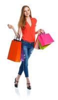 Happy lovely woman with shopping bags over white photo