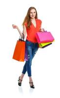 Happy lovely woman with shopping bags over white photo