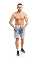 Happy athletic man with dumbbells on the white photo