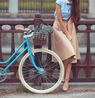 Young beautiful, elegantly dressed woman with bicycle photo